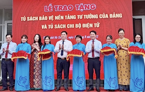 Các đại biểu thực hiện nghi thức trao tặng Tủ sách bảo vệ nền tảng tư tưởng của Đảng.